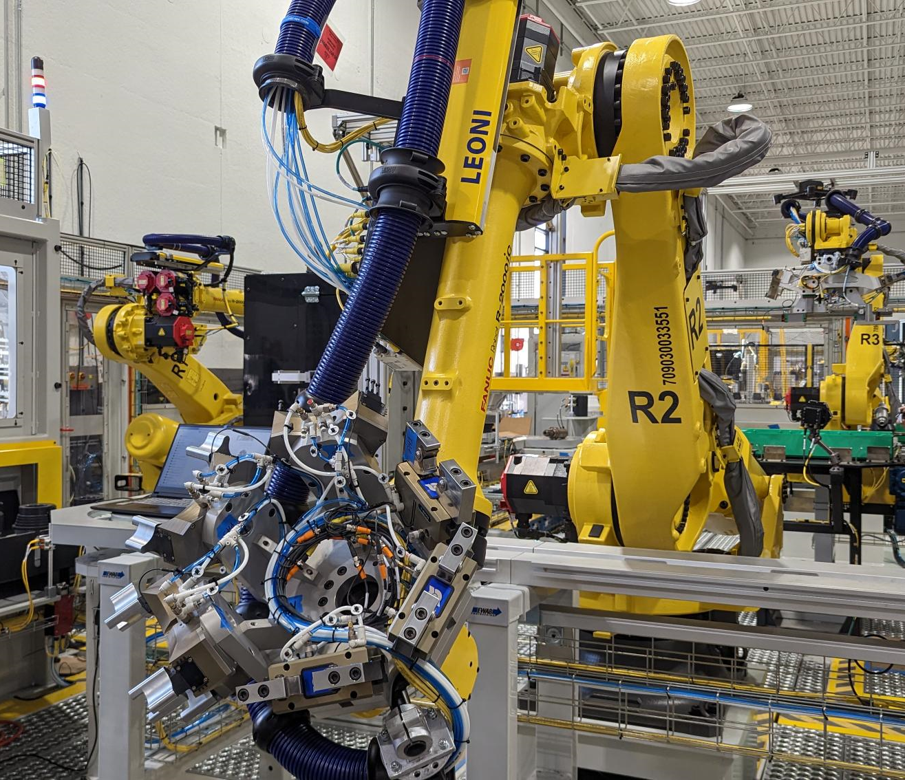 FANUC robot arm and automation system working with multiple components