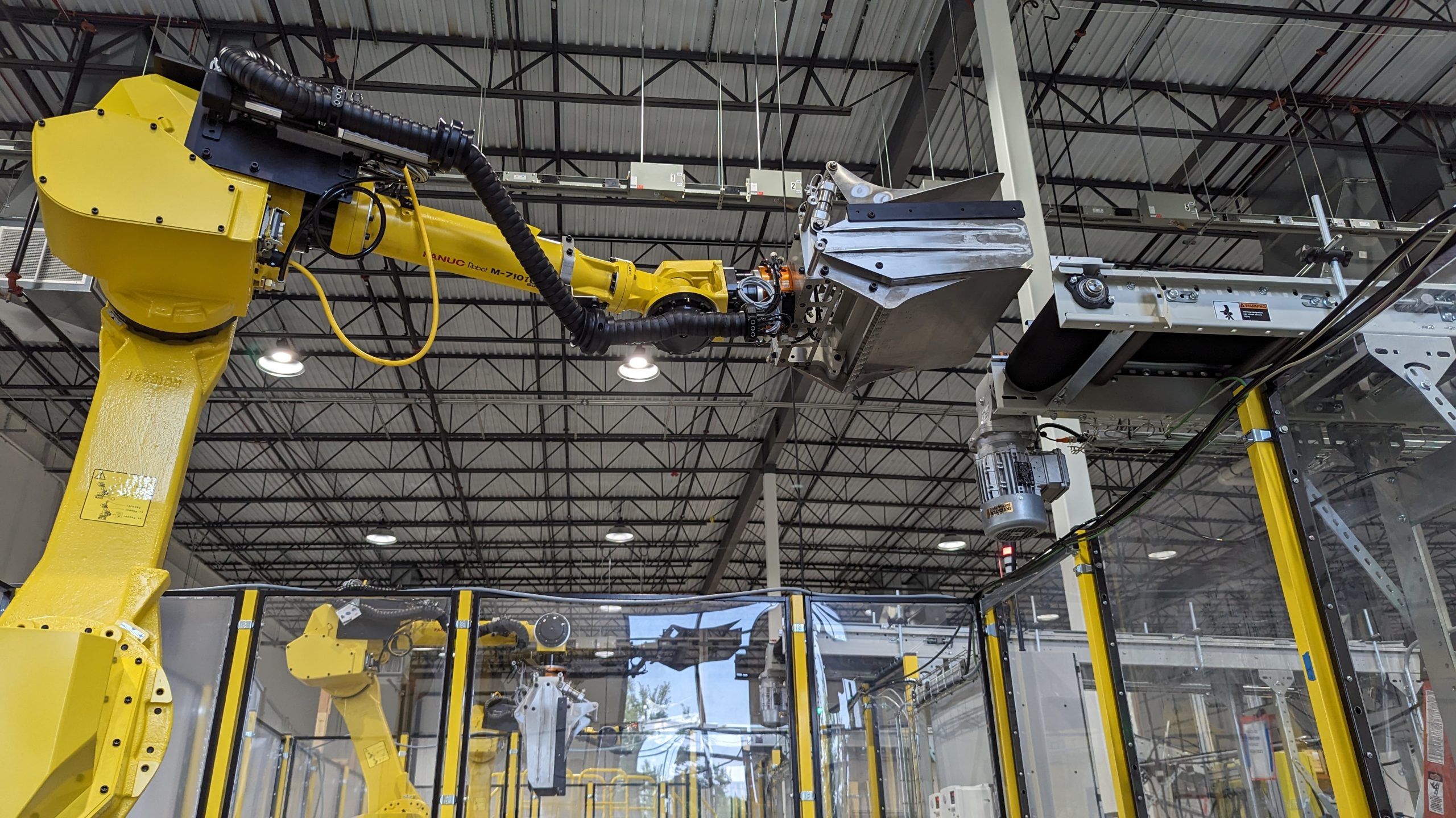 Matrix Design robot arm working with heavy equipment in warehouse