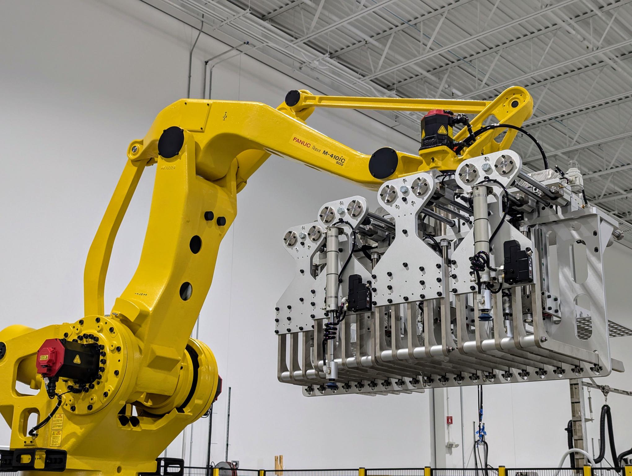FANUC robot arm holding a heavy duty machine