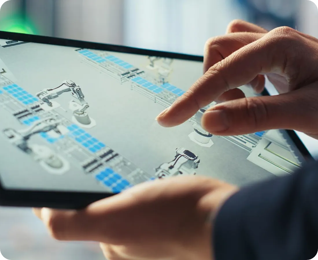 Employee using a tablet to design a custom robotic system