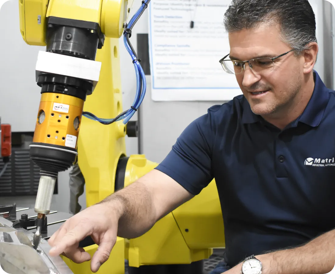 Matrix Design employee working on a robotic arm